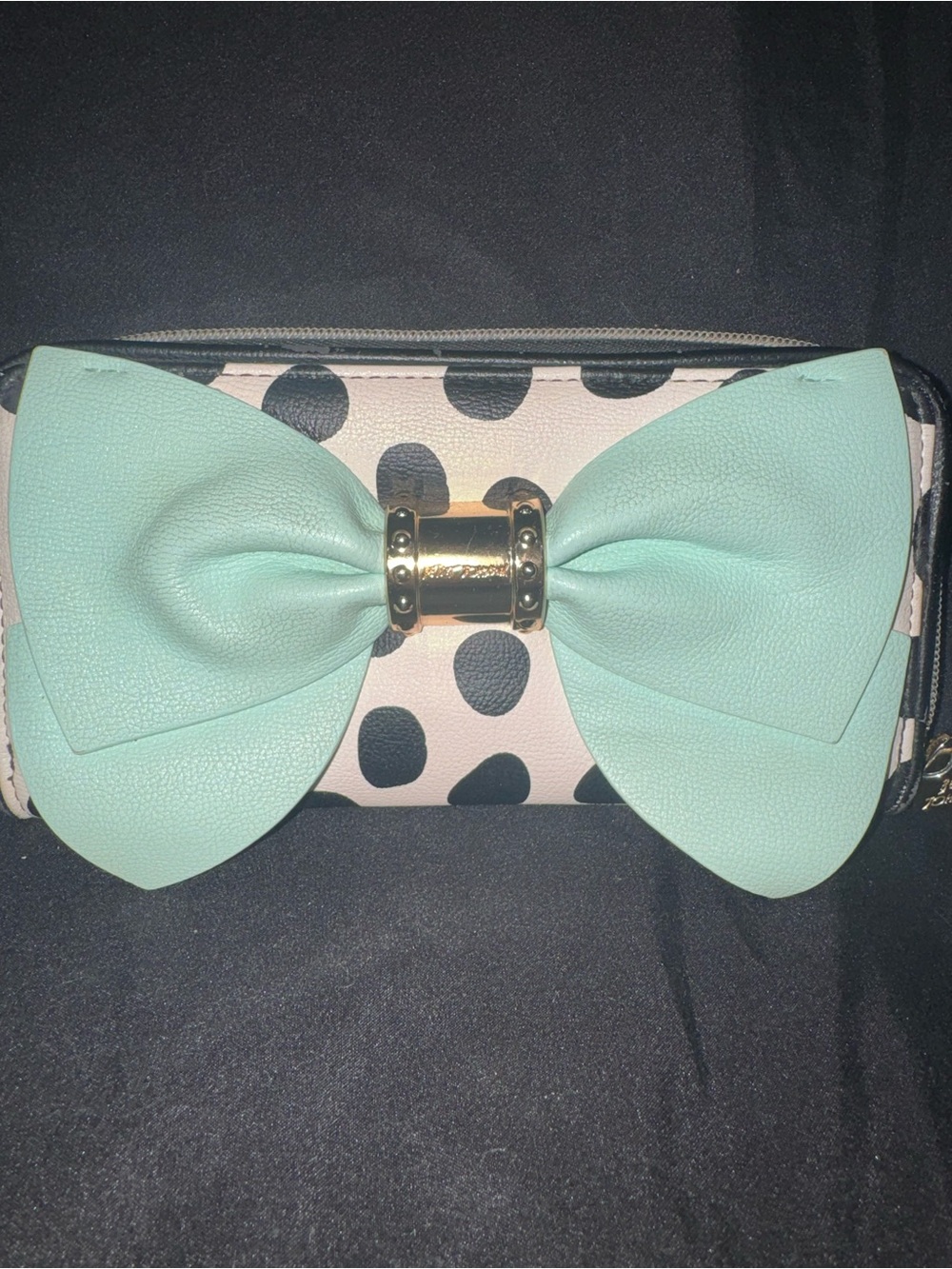 This is a Betsey Johnson polka dot wallet featuring a prominent mint green bow